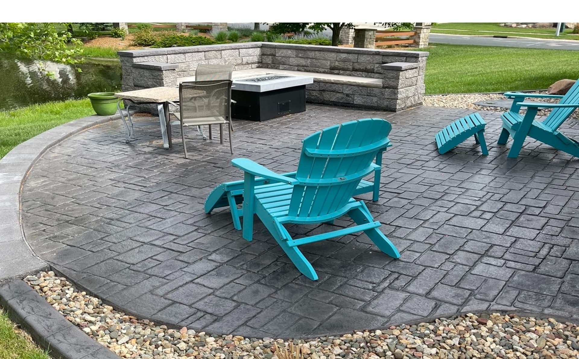 Stamped concrete patio with fire pit and outdoor seating in Owatonna, Minnesota